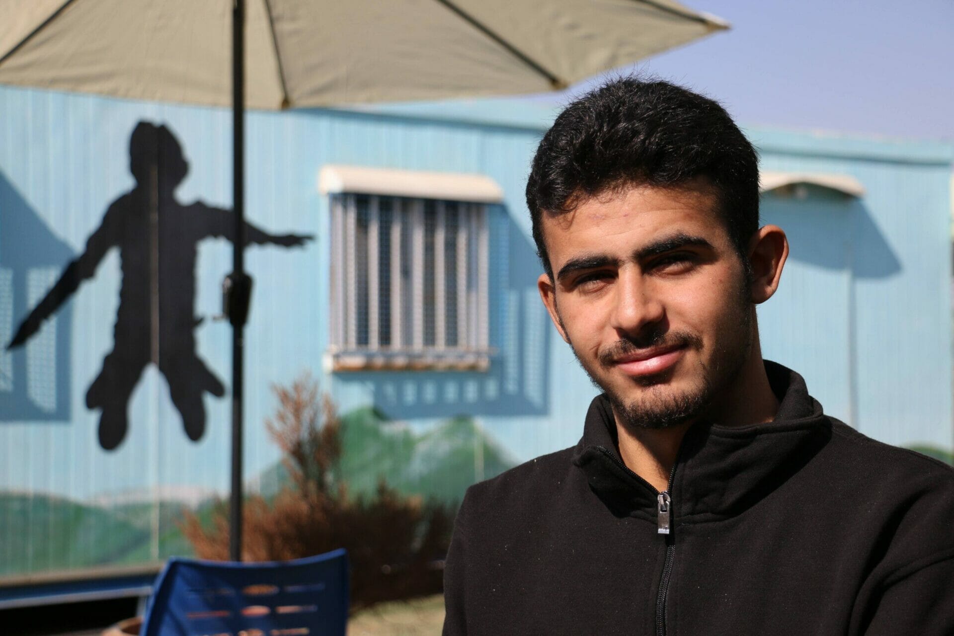 Tahir, a Syrian refugee who has been taking part in sewing classes funded by All We Can.